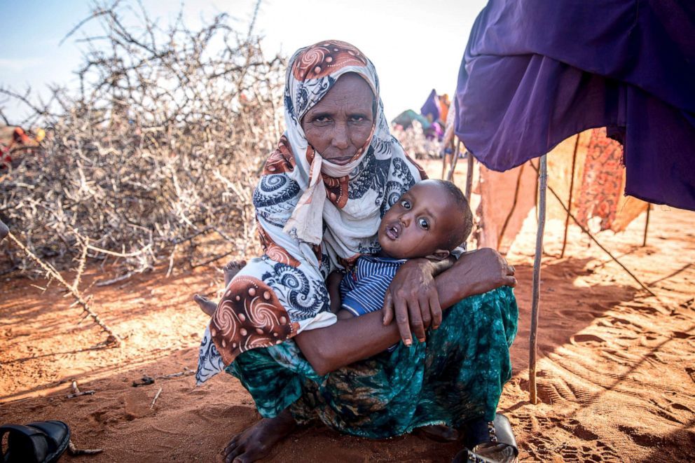 PHOTO: A woman and her family have been displaced due to drought conditions, migrating to Dollow, Somalia, in search for aid. Extreme drought has killed hundreds of thousands of livestock, and the rising costs of food prices has caused food insecurity.