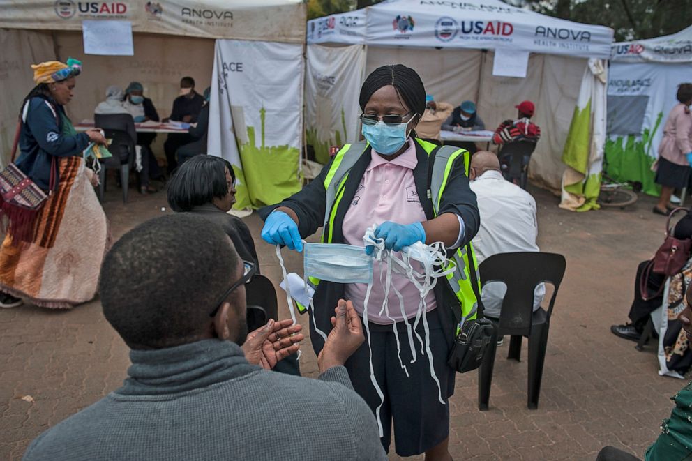 PHOTO: A nurse gives a mask to a citizen before the COVID-19 testing in Johannesburg, South Africa, April 7, 2020.