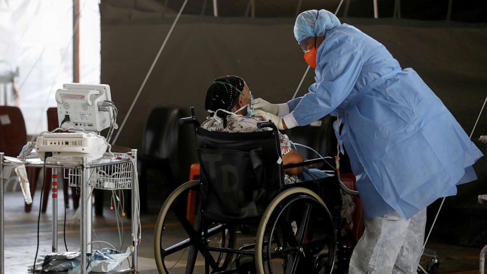 PHOTO: A healthcare worker tends to a patient at a temporary ward set up during the coronavirus disease (COVID-19) outbreak, at Steve Biko Academic Hospital in Pretoria, South Africa, Jan. 19, 2021.