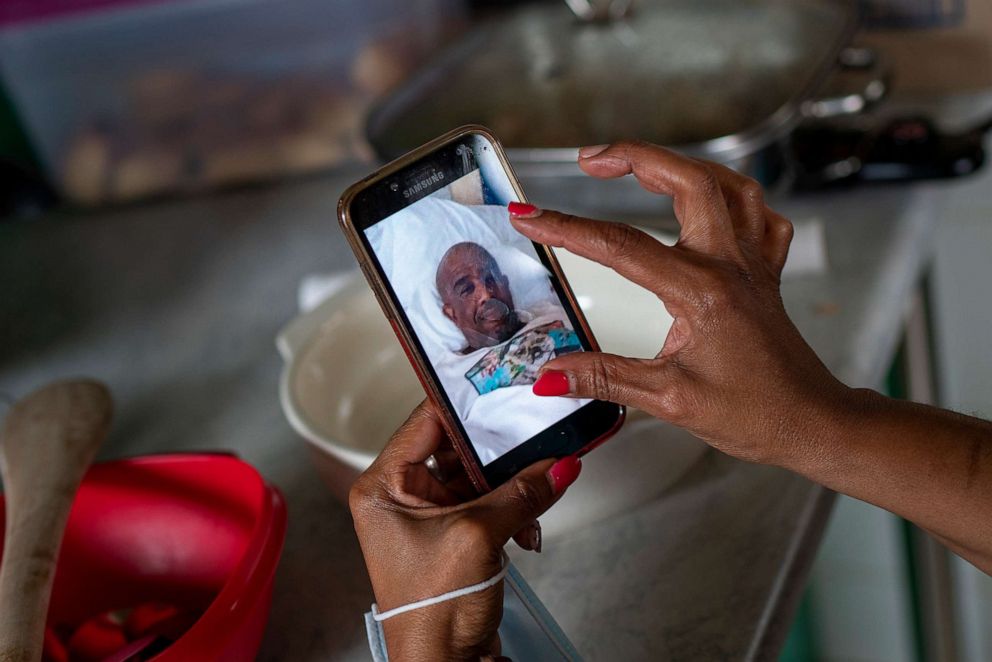 PHOTO: Menge Mokwatle shares a photograph of her late husband Benedict Sami Vilakazi, who died of COVID-19, during an Ukugeza cleansing ceremony at Vilakazi's home in Soweto, South Africa, Nov. 21, 2020.