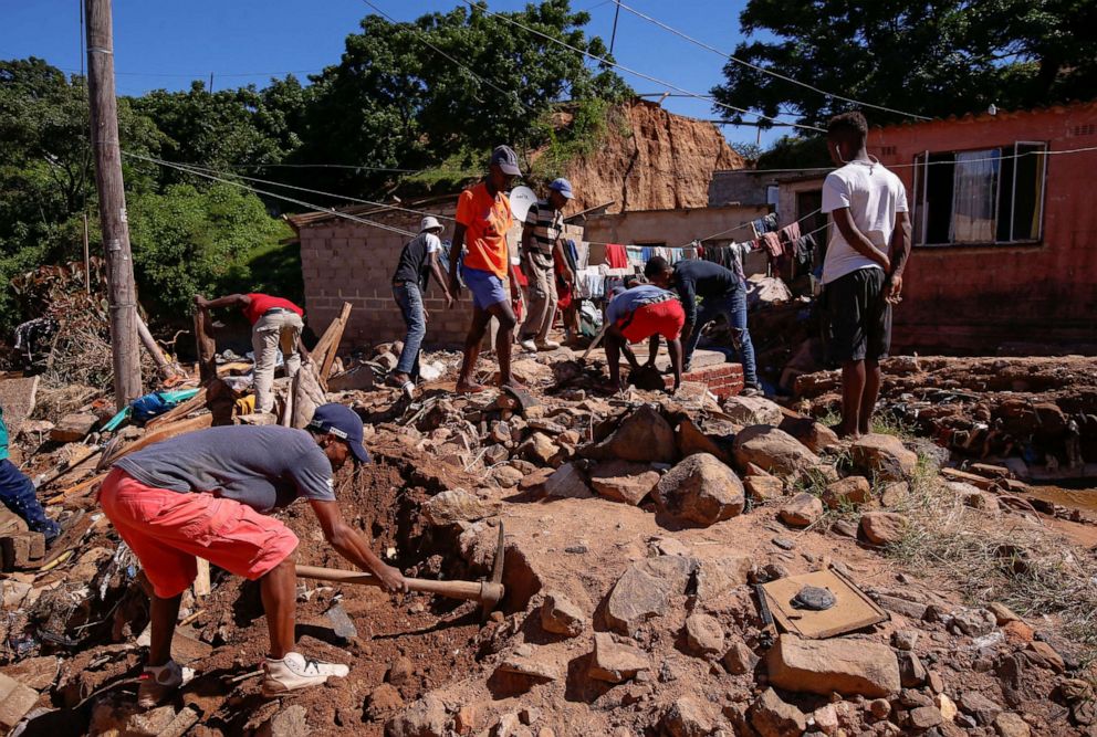 PHOTO: Residents sift through rubble, looking for bodies after heavy rains caused flooding in Ntuzuma near Durban, South Africa, April 20, 2022.