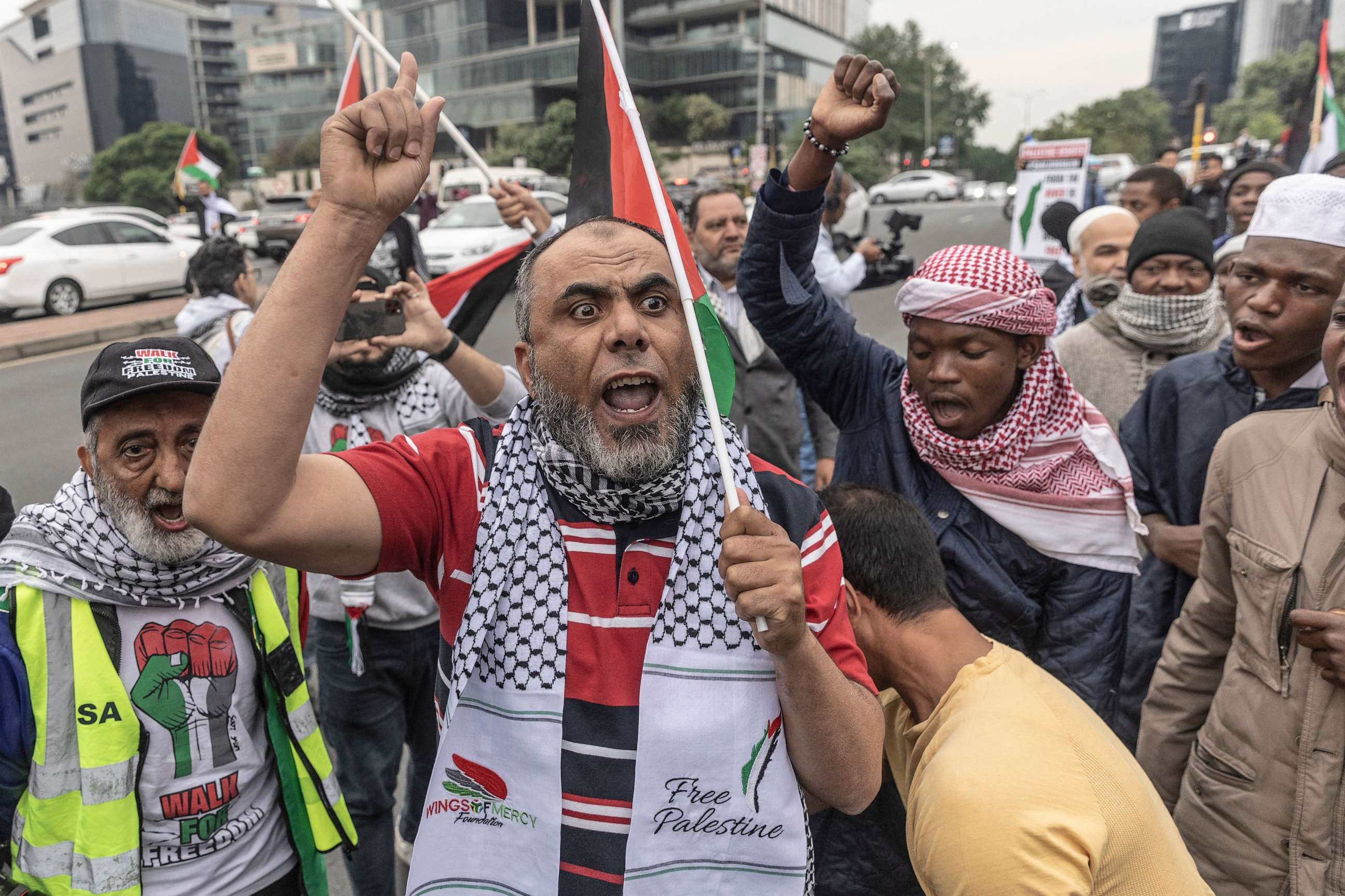 PHOTO: Protesters shout slogans and wave flags during a pro Palestinian demonstration near the US consulate in Sandton, Johannesburg, on October 11, 2023.