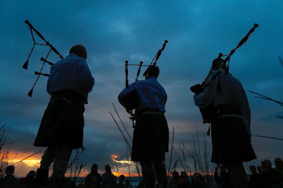 PHOTO: Men play bag-pipes during New Year's eve celebrations at sunset on Scarborough beach in Cape Town, South Africa, Dec. 31, 2017. 