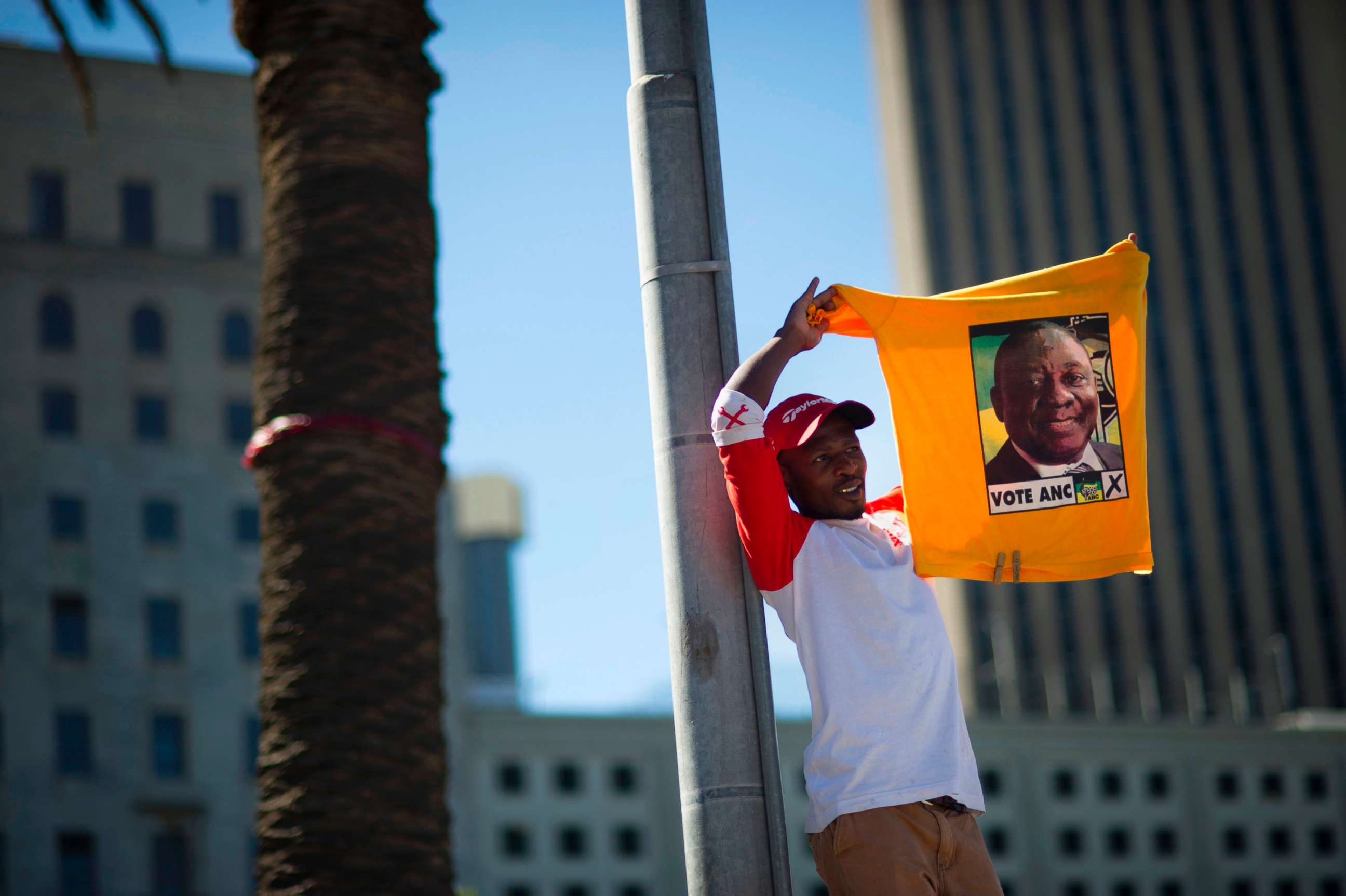 PHOTO: A supporter of South Africa's ruling African National Congress holds up a shirt featuring newly-elected ANC president and South African Deputy President, Cyril Ramaphosa, during a rally on Feb. 11, 2018 in Cape Town.