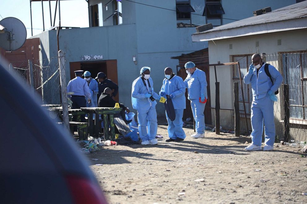 PHOTO: Forensic personnel investigate after the deaths of patrons found inside the Enyobeni Tavern, in Scenery Park, outside East London in the Eastern Cape province, South Africa, June 26, 2022.
