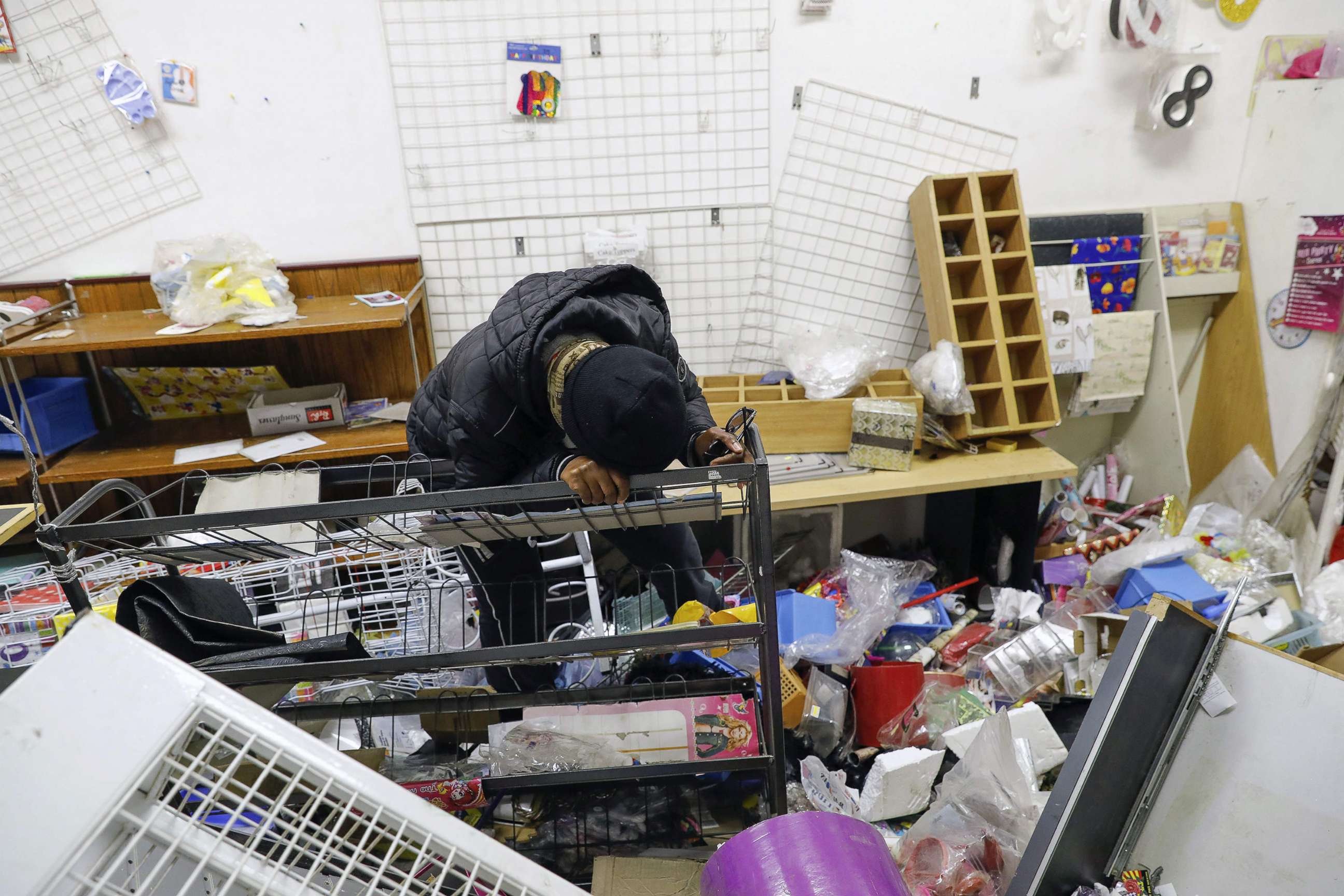 PHOTO: Thandi Johnson, a shop owner, weeps inside her looted store at the Diepkloof Square area in Soweto, Johannesburg on July 13, 2021.