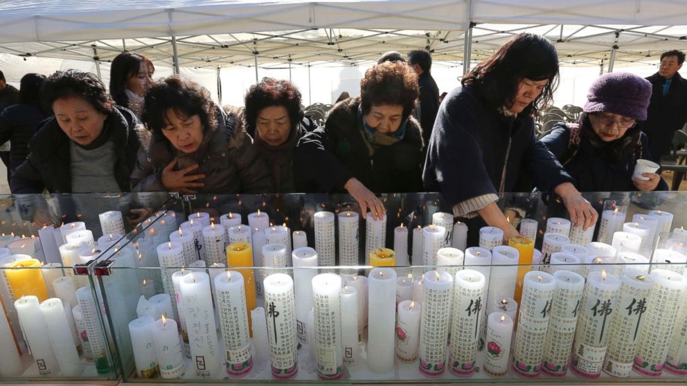 Women place candles during a special service to wish for their family members' success in the college entrance exams at the Jogye temple in Seoul, South Korea, Nov. 23, 2017.