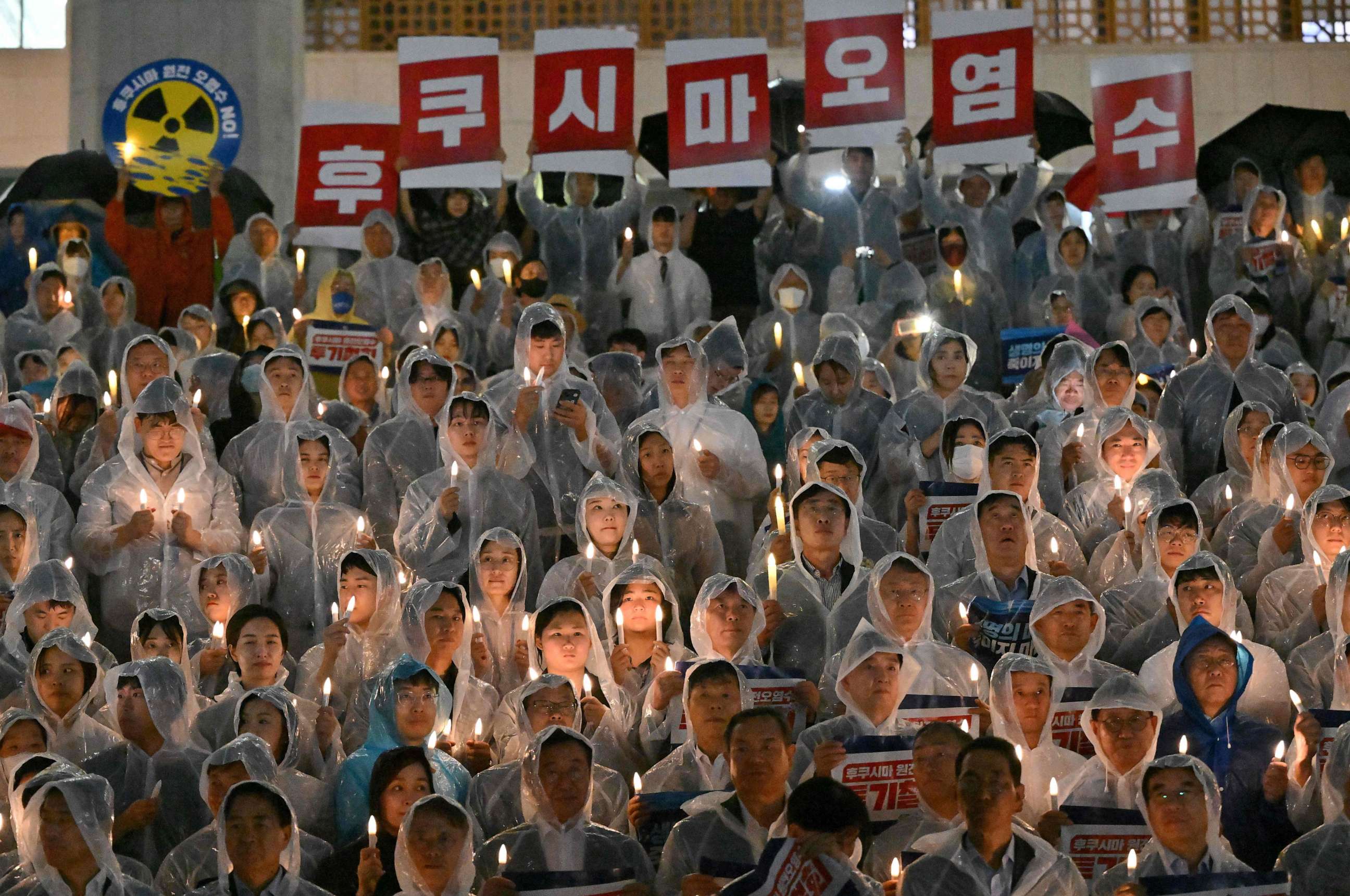 PHOTO: South Korea's main opposition Democratic Party members hold signs reading "Fukushima contaminated water" during a rally against Japan's plan to release treated water from Fukushima, at the National Assembly in Seoul on August 23, 2023.