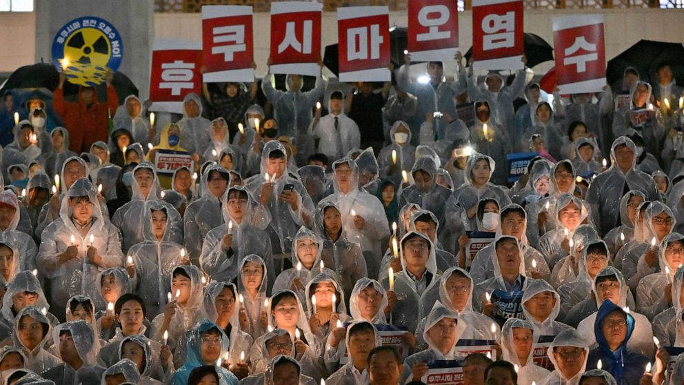 PHOTO: South Korea's main opposition Democratic Party members hold signs reading "Fukushima contaminated water" during a rally against Japan's plan to release treated water from Fukushima, at the National Assembly in Seoul on August 23, 2023.