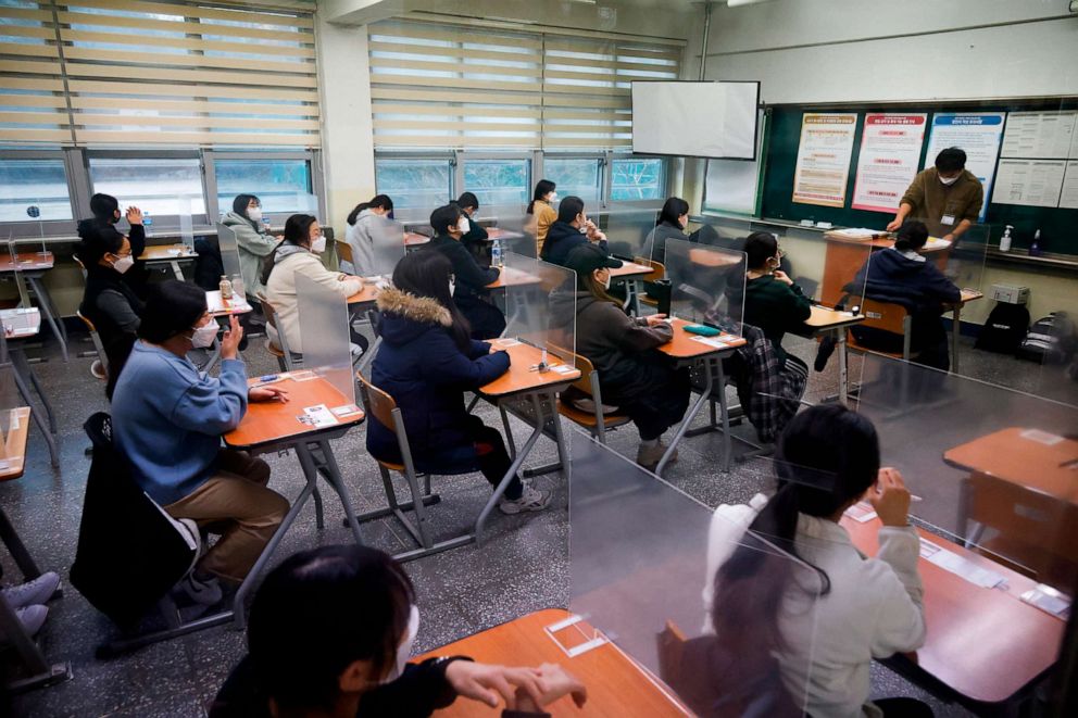 PHOTO: Students wearing face masks wait for the start of the annual college entrance examination amid the coronavirus pandemic at an exam hall in Seoul, South Korea, Dec. 3, 2020.