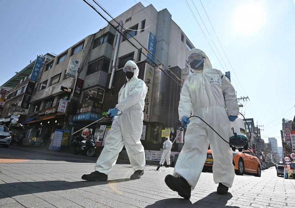 PHOTO: South Korean soldiers wearing protective gear spray disinfectant on the street to help prevent the spread of the novel coronavirus, at Gangnam district in Seoul, South Korea, on March 5, 2020.