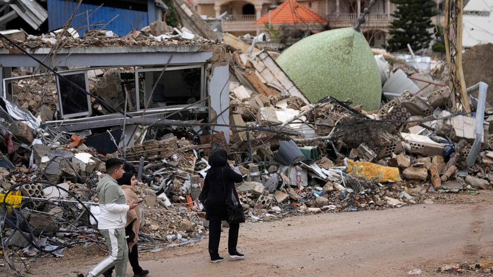 PHOTO: Displaced residents returning to their village walk past a destroyed mosque in the town of Bint Jbeil, southern Lebanon, on Nov. 27, 2024.