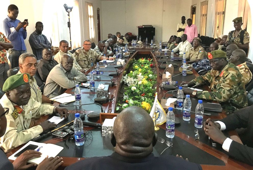 PHOTO: In this photo taken Thursday, Nov. 22, 2018, a South Sudan armed opposition commander Ashab Khamis, far-left, and a government army Gen. Keer Kiir Keer, far-right, attend high level talks in Wau, South Sudan.