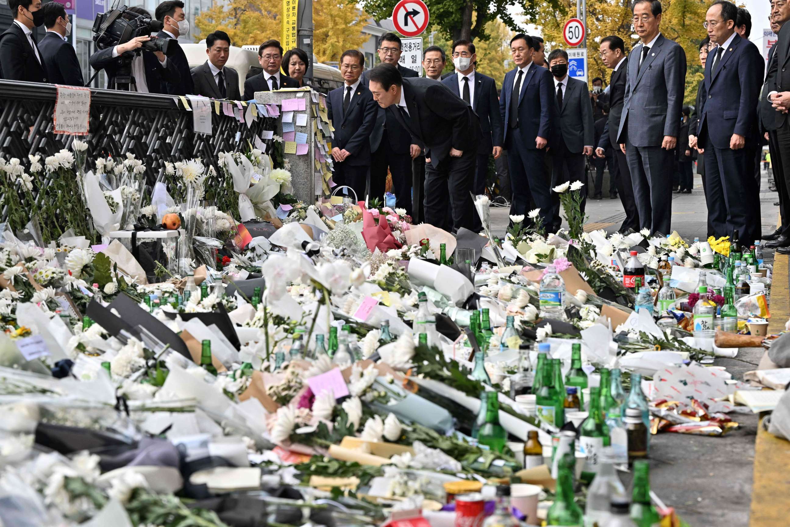 PHOTO: South Korean President Yoon Suk-yeol looks at messages of mourners a makeshift memorial for the victims of the deadly Halloween crowd surge, outside a subway station in the district of Itaewon in Seoul on November 1, 2022. 