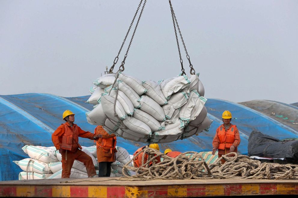 PHOTO: Workers load imported soybeans at a port in Nantong in China, March 22, 2018.
