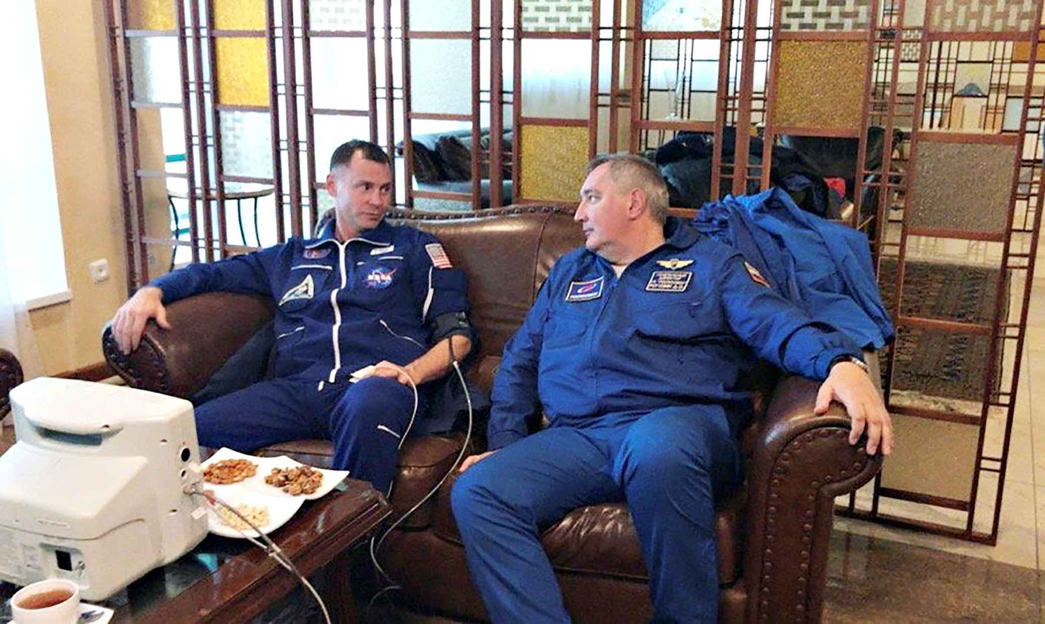 U.S. astronaut Nick Hague, left, speaks with head of the Russian space agency Roscosmos Dmitry Rogozin, after the Soyuz MS-10 Hague was in made an emergency landing following a failure of its booster rockets, in Zhezkazgan, Kazakhstan on Oct. 11, 2018. 