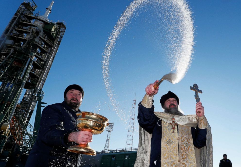 PHOTO: An Orthodox priest conducts a blessing in front of the Soyuz MS-11 spacecraft set on the launchpad ahead of its upcoming launch, at the Baikonur Cosmodrome in Kazakhstan, Dec. 2, 2018. 