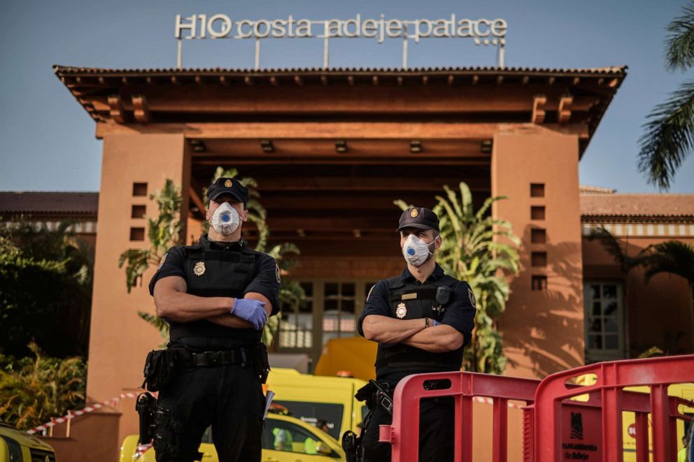 PHOTO: Police officers wearing masks stand in front of the H10 Costa Adeje Palace hotel in La Caleta, in the Canary Island of Tenerife, Spain, on Feb. 26, 2020.