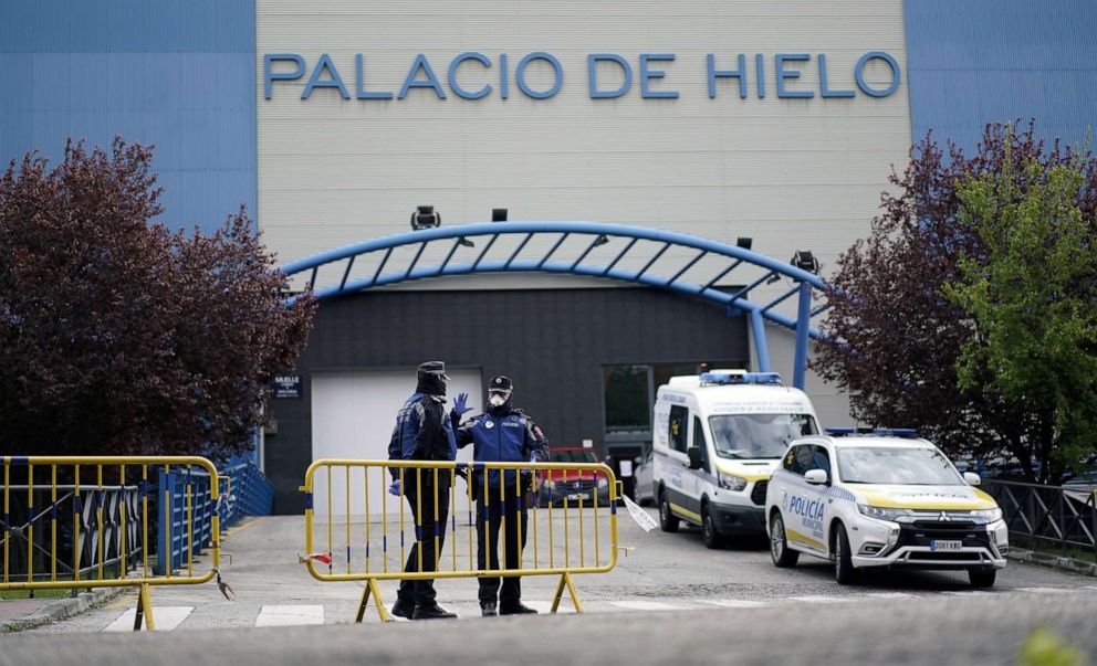 PHOTO: Local police stand guard outside an ice rink, which will be used as a morgue, during the coronavirus disease (COVID-19) outbreak in Madrid, Spain, March 24, 2020.