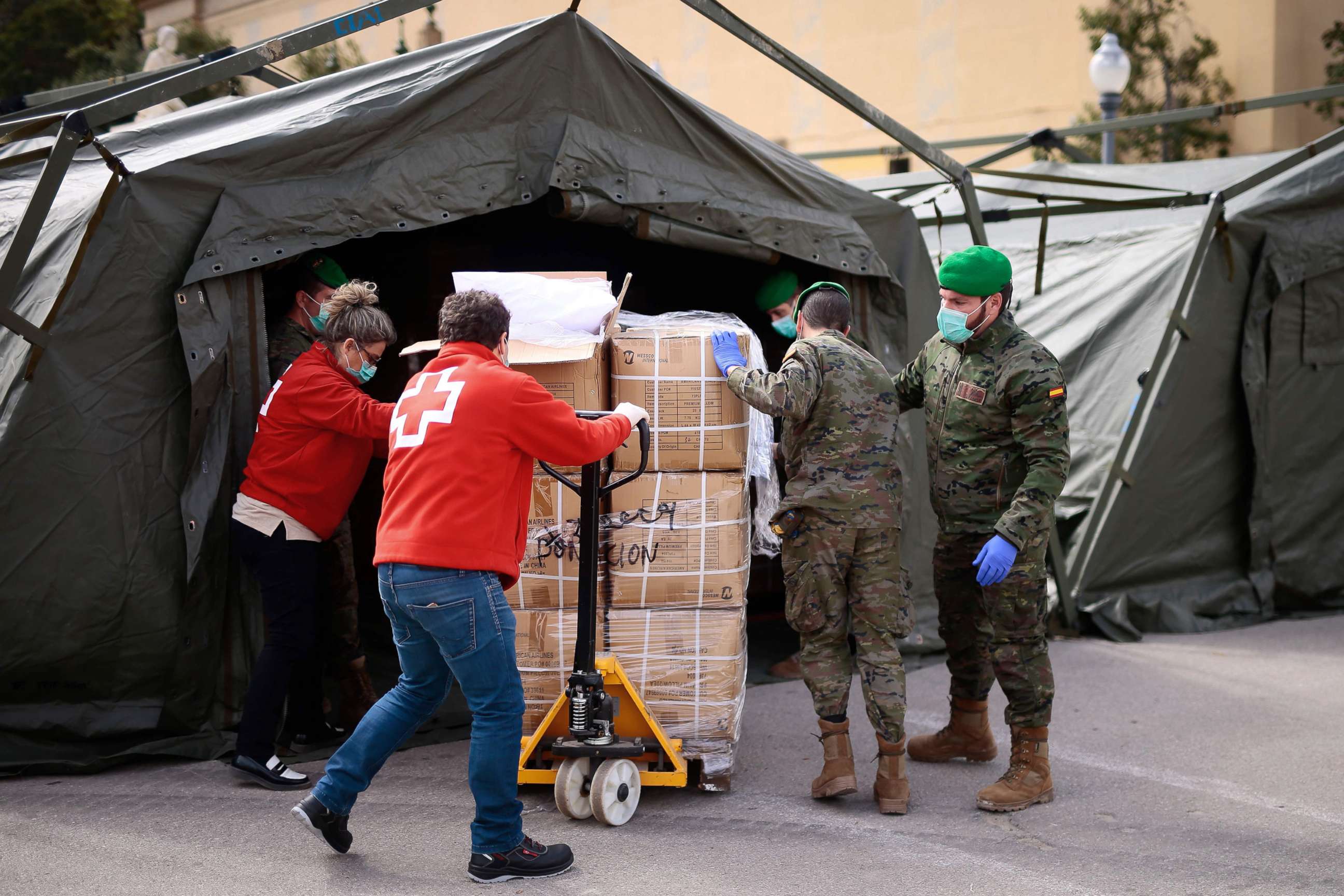 PHOTO: Spanish soldiers and Red Cross members gather equipment for a temporary hospital being set up at the Fira Barcelona Montjuic centre in Barcelona, Spain, March 25, 2020, during the new coronavirus epidemic.