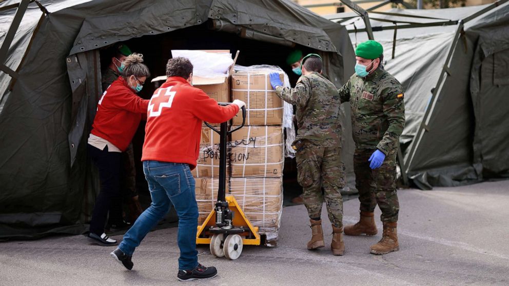 PHOTO: Spanish soldiers and Red Cross members gather equipment for a temporary hospital being set up at the Fira Barcelona Montjuic centre in Barcelona, Spain, March 25, 2020, during the new coronavirus epidemic.