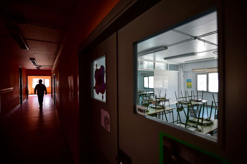 PHOTO: A teacher walks along a hallway of an empty public school in small Spanish Basque village of Labastida, northern Spain, March 11, 2020, after schools were closed due to a spike in coronavirus cases.