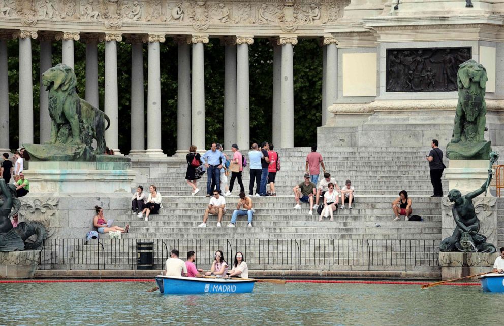 PHOTO: People have a break and some row in a boat on the Retiro park's lake in central Madrid, as Spaniards are bracing themselves for an early heat wave, on April 25, 2023.