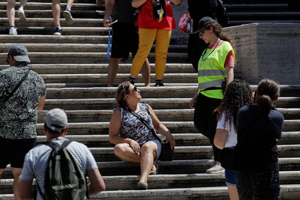 PHOTO: A municipal police officer asks a woman not to sit on the Spanish Steps, in Rome, Aug. 7, 2019.