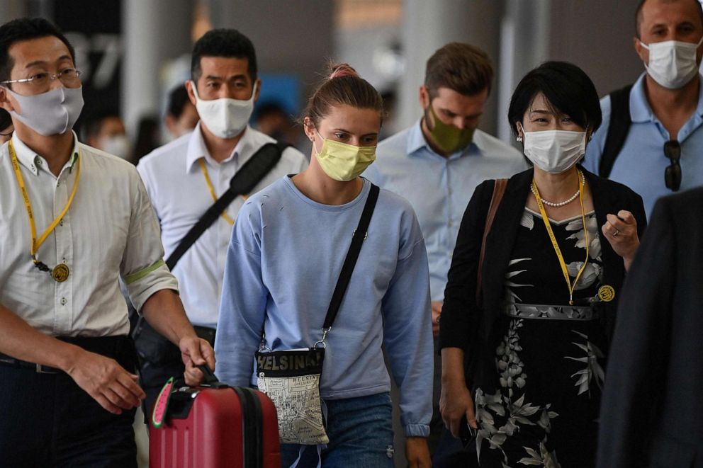 PHOTO: Belarus athlete Krystsina Tsimanouskaya walks through Terminal 1 before boarding her Vienna-bound flight at Narita International Airport in Narita, Chiba Prefecture, outside Tokyo on Aug. 4, 2021.