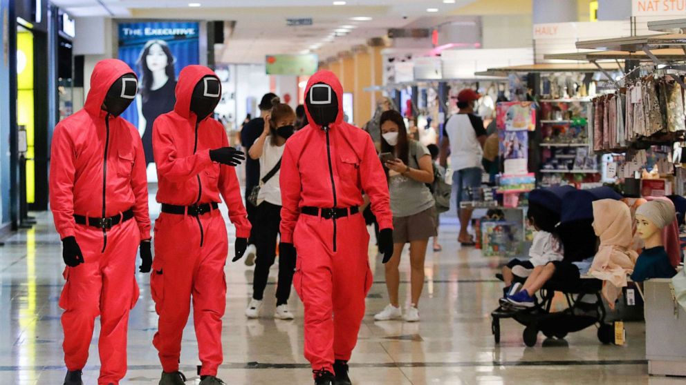 PHOTO: Pink officers from Squid Game walk inside Sunway Pyramid shopping mall in Subang, outside Kuala Lumpur in Malaysia, Oct. 20, 2021.