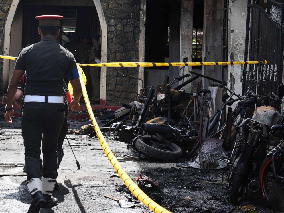 PHOTO: Sri Lankan security personnel walk past debris outside Zion Church following an explosion in Batticaloa, Sri Lanka, April 21, 2019.