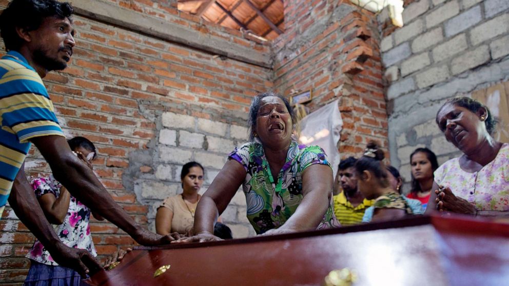 PHOTO: Lalitha, center, weeps beside the coffin with the remains of a a victim of Easter Sunday bombing at St. Sebastian Church, after it returning home in Negombo, Sri Lanka, April 22, 2019.