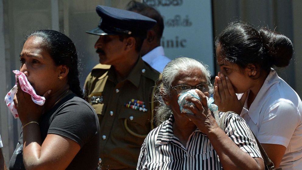 PHOTO: Sri Lankan woman looks into a container where bodies of bomb blast victims are kept at a hospital in Negombo on April 22, 2019, a day after a nearby church was hit in a series of explosions targeting churches and luxury hotels in Sri Lanka.