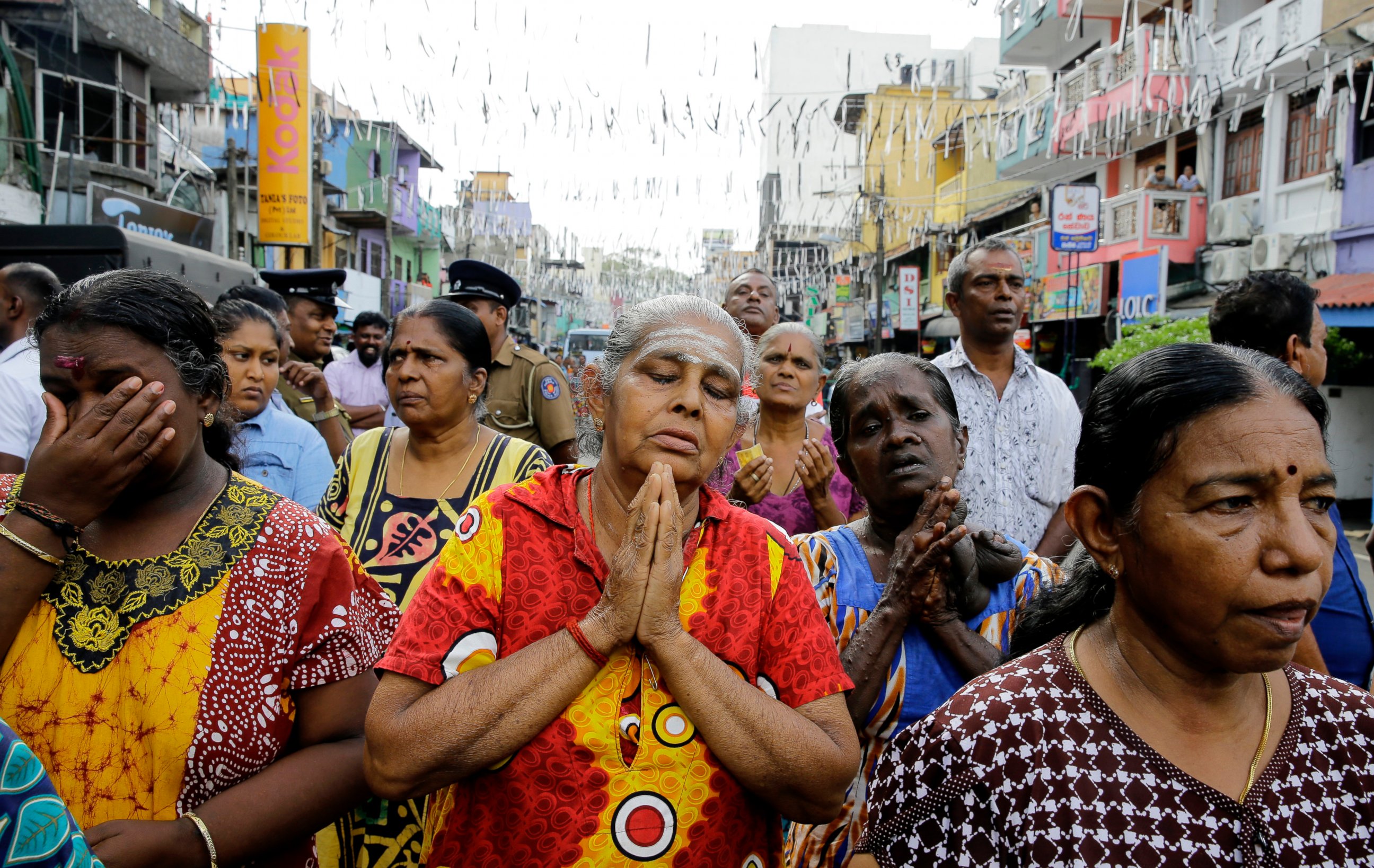 PHOTO: Sri Lankan Catholics pray standing on a road during a brief holly mass held outside the exploded St. Anthony's Church in Colombo, Sri Lanka, Sunday, April 28, 2019.