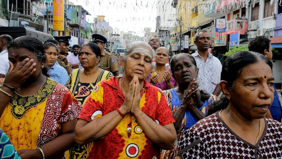 PHOTO: Sri Lankan Catholics pray standing on a road during a brief holly mass held outside the exploded St. Anthony's Church in Colombo, Sri Lanka, Sunday, April 28, 2019.