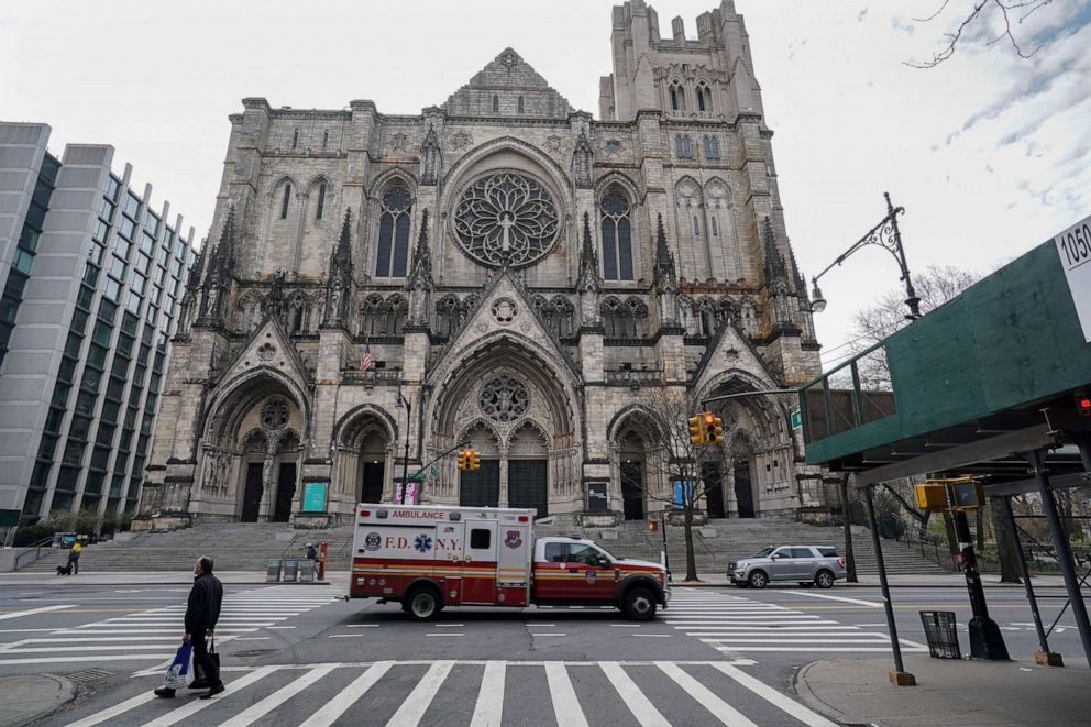 PHOTO: Cathedral of St. John the Divine, the largest Gothic church in the world will become an emergency field hospital later this week. An ambulance passes the church, April 7, 2020 in New York.
