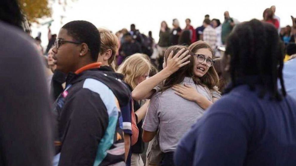 PHOTO: People gather outside after a shooting at Central Visual and Performing Arts high school in St. Louis, on Oct. 24, 2022.