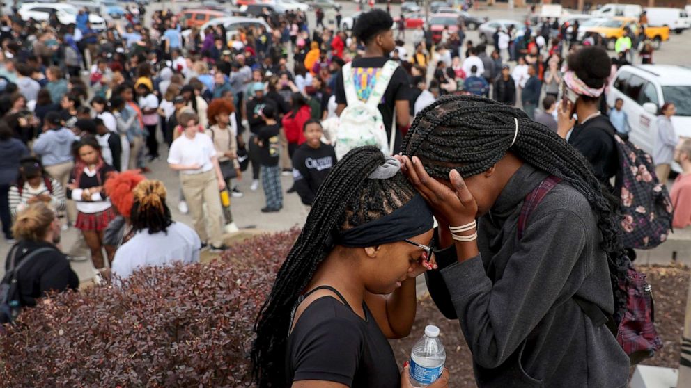 PHOTO: Students stand in the parking lot outside Central High School for the Visual and Performing Arts after a school shooting in St. Louis, Oct. 24, 2022.