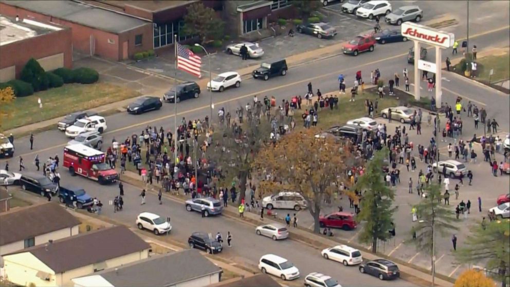 PHOTO: Students and faculty gather with first responders outside the Central Visual and Performing Arts High School in St. Louis, Oct. 24, 2022, following a shooting.