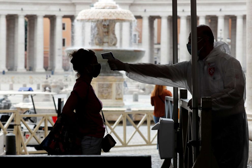 PHOTO: A woman has her temperature checked on the day of St. Peter's Basilica's full reopening in Vatican City on May 18, 2020, as both the Vatican and Italy ease measures put in place to curb the spread of the novel coronavirus.