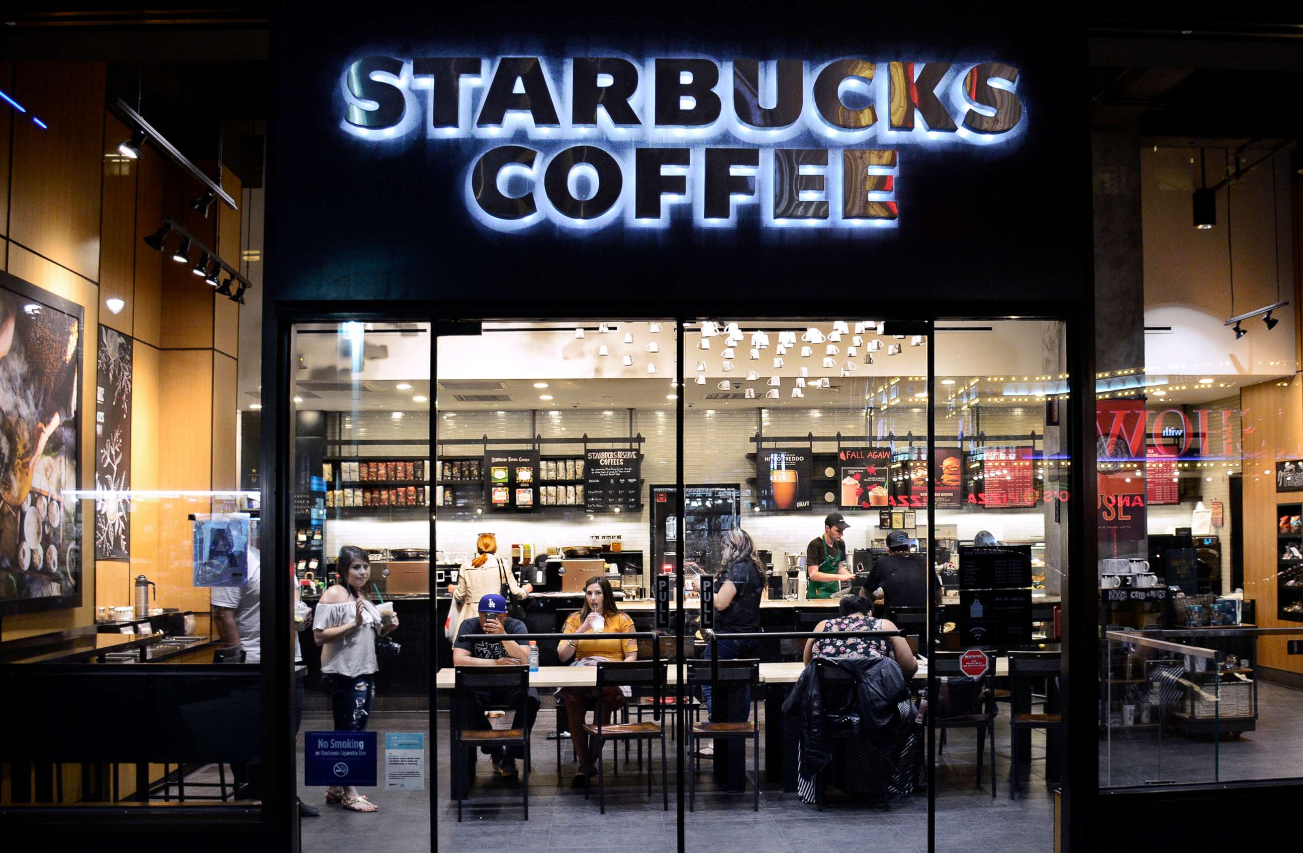 PHOTO: Customers eat and drink in a Starbucks Coffee shop in New York City.