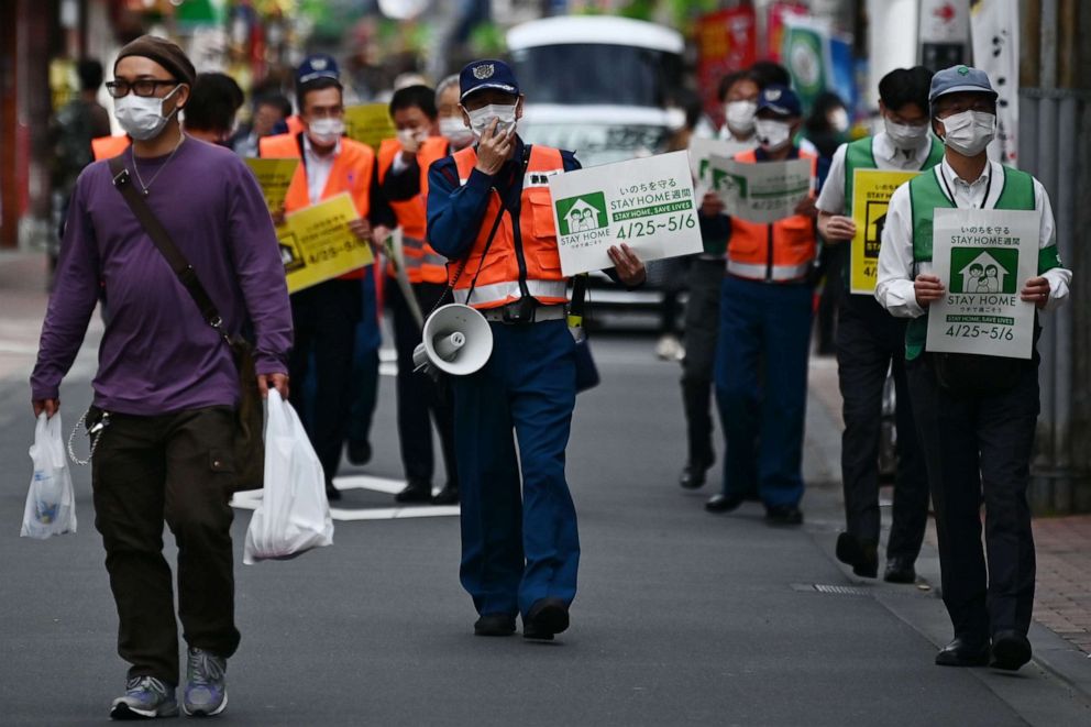 PHOTO: Municipal employees patrol a street asking people to stay home amid the novel coronavirus outbreak in Tokyo, Japan, on May 4, 2020.