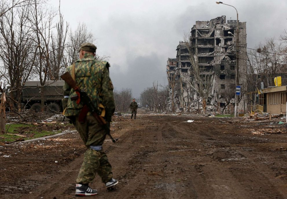PHOTO: Service members of pro-Russian troops walk in the street during fighting in Ukraine-Russia conflict near a plant of Azovstal Iron and Steel Works company in the southern port city of Mariupol, Ukraine, April 12, 2022.