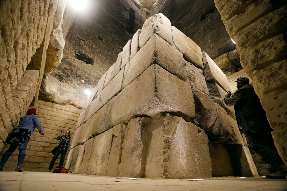 PHOTO: Tourists take pictures at the burial chamber and sarcophagus of King Djoser inside the standing step pyramid of Saqqara, south of Cairo, Egypt, March 5, 2020.