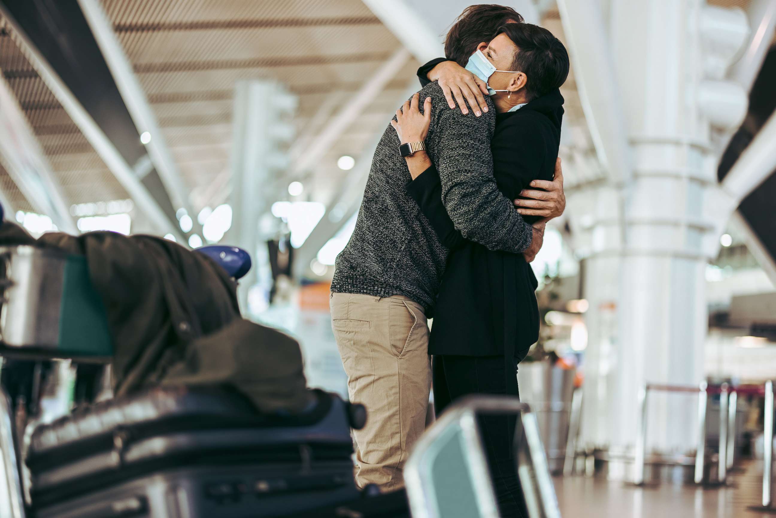 PHOTO: Stock photo of couple hugging at airport.