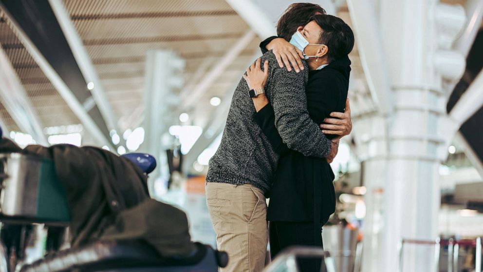 PHOTO: Stock photo of couple hugging at airport.