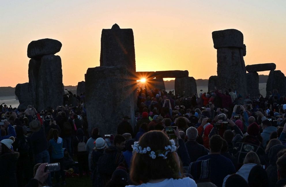 PHOTO: Revelers watch the sun rise at Stonehenge, near Amesbury, England, June 21, 2019, as they celebrate the summer solstice.