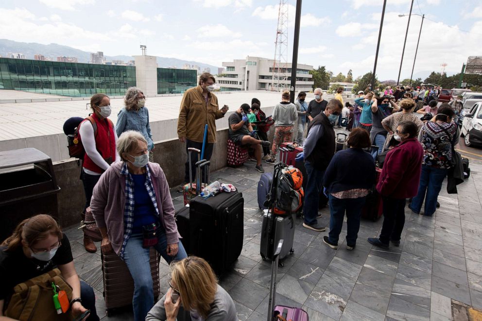 PHOTO: Travelers wait to take a charter flight coordinated by the U.S. embassy at La Aurora airport in Guatemala City, March 23, 2020. 