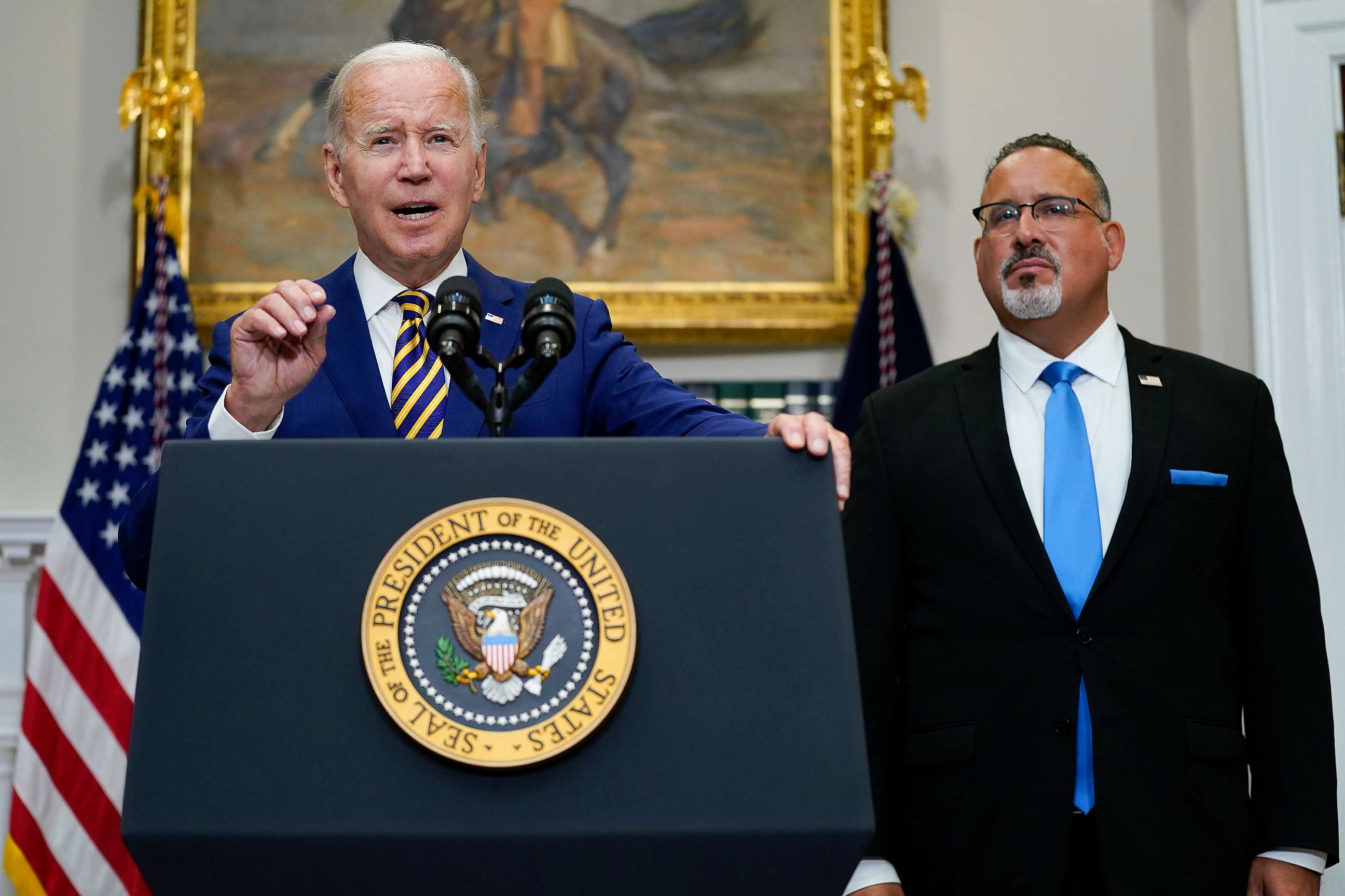 PHOTO: President Joe Biden speaks about student loan debt forgiveness with Education Secretary Miguel Cardona in the Roosevelt Room of the White House, Aug. 24, 2022.