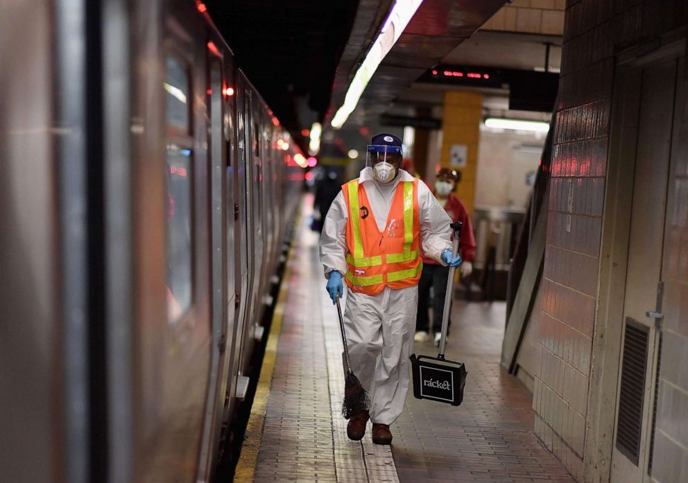 PHOTO: A MTA worker cleans subway trains at a station, May 7, 2020, in New York City.